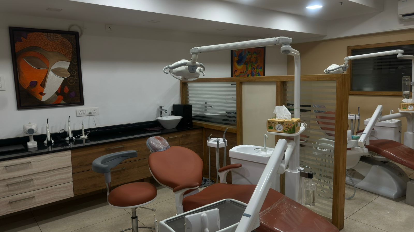 The Dental Office Mangaluru — Pumpwell treatment room with modern dental chair and artwork